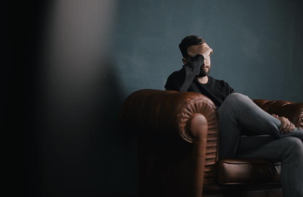 Depressed Man sitting on couch