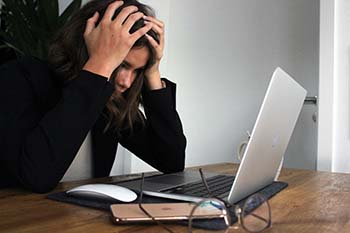 stressed woman looking at computer